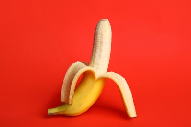 Photo of Fresh banana on red background. Sex concept
