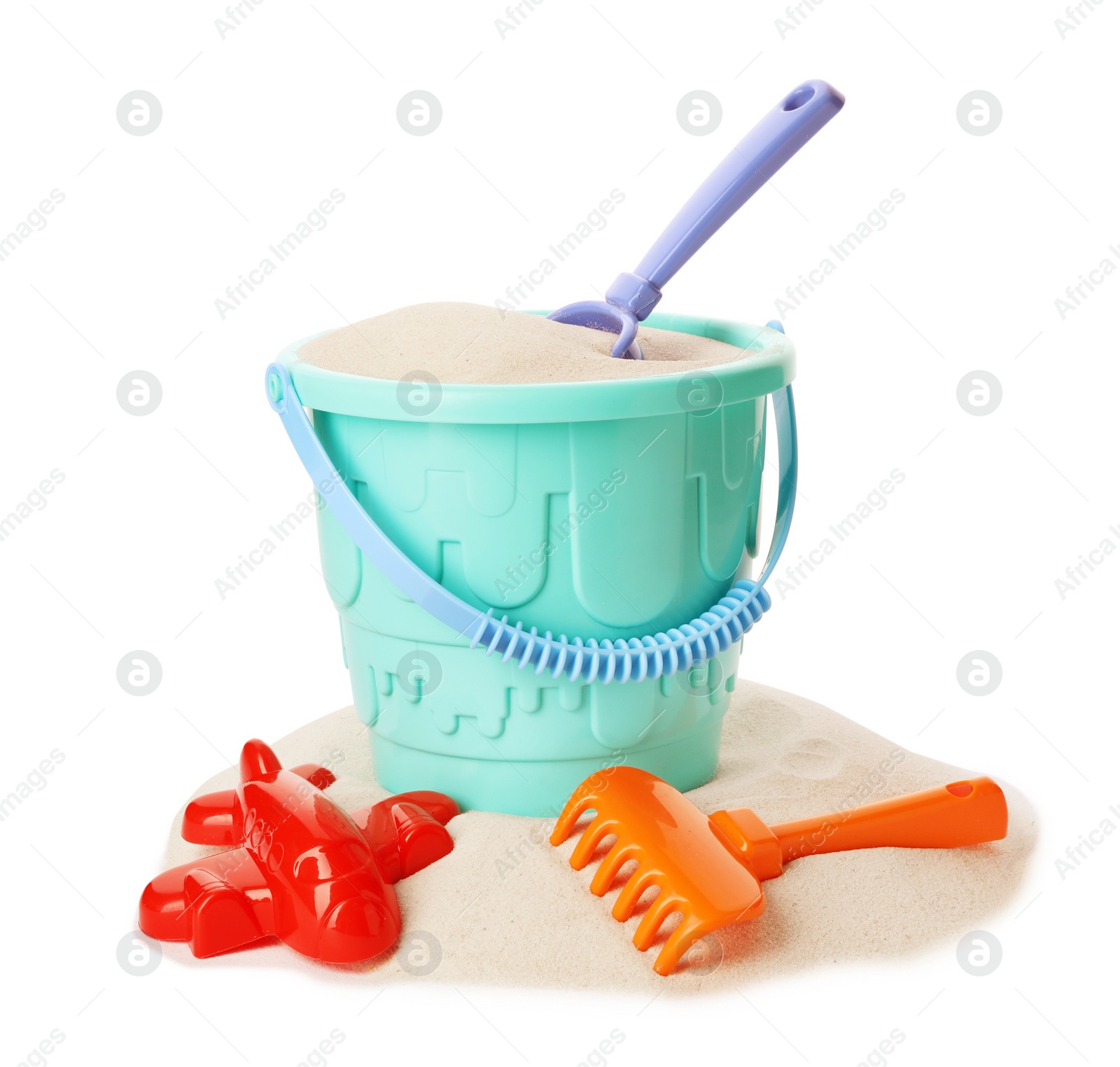 Photo of Plastic beach toys on pile of sand, white background