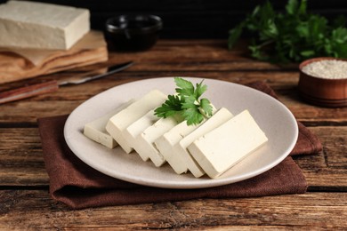 Delicious tofu with parsley on wooden table