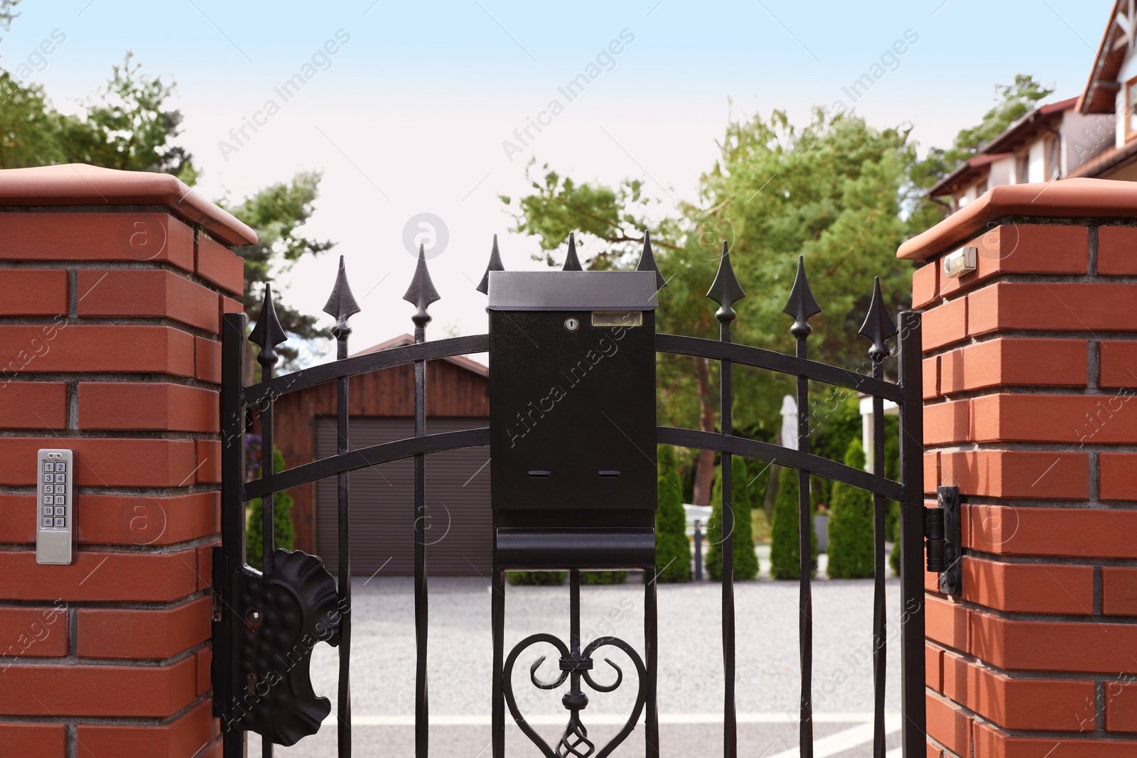 Photo of Black metal letter box on fence outdoors