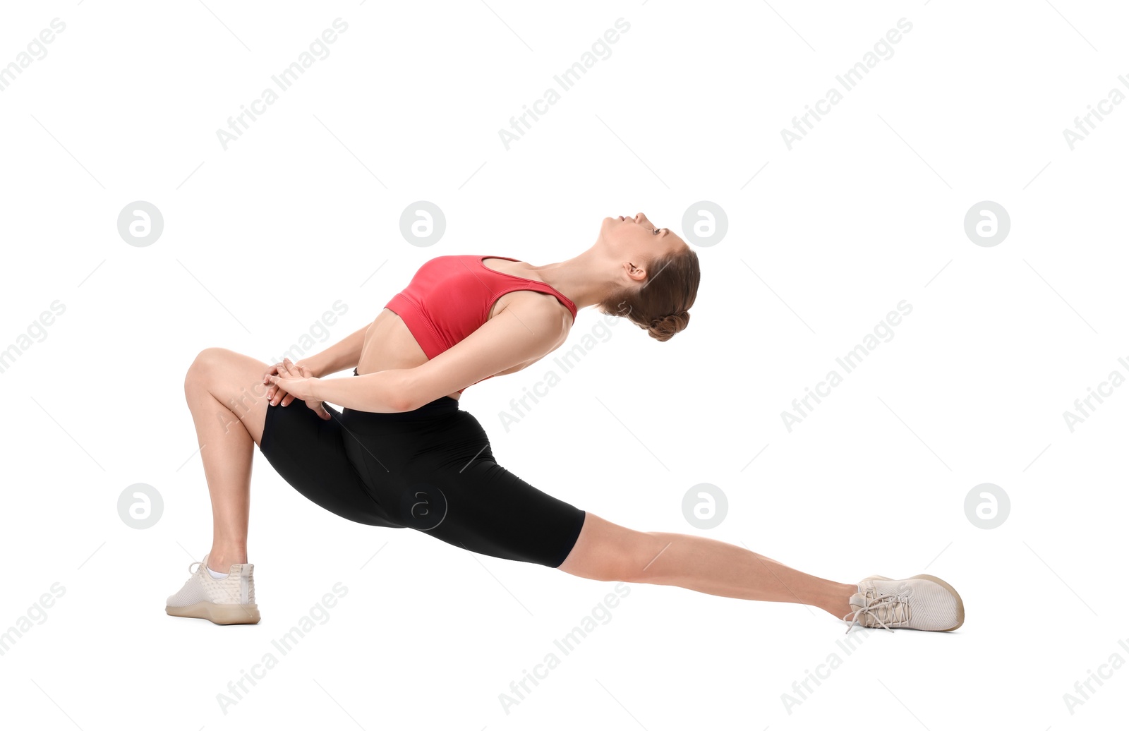 Photo of Yoga workout. Young woman stretching on white background