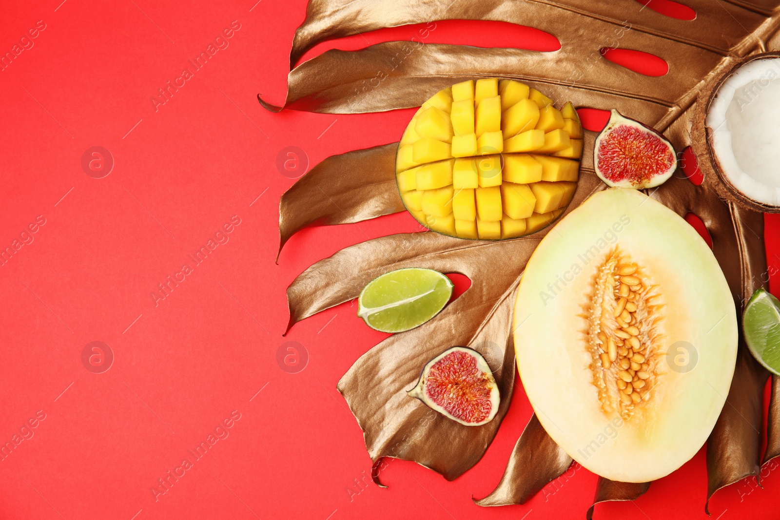 Photo of Flat lay composition with melon, other fruits and space for text on color background