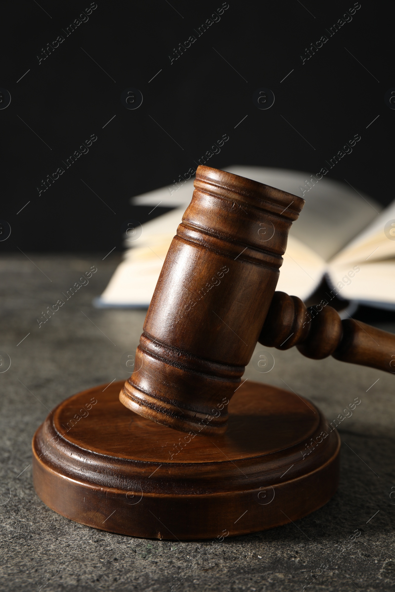 Photo of Law concept. Gavel and book on grey textured table, closeup