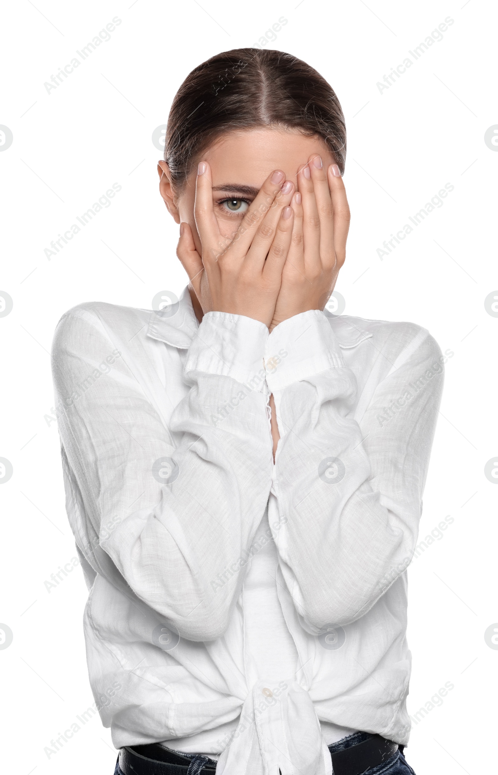 Photo of Embarrassed young woman covering face with hands on white background