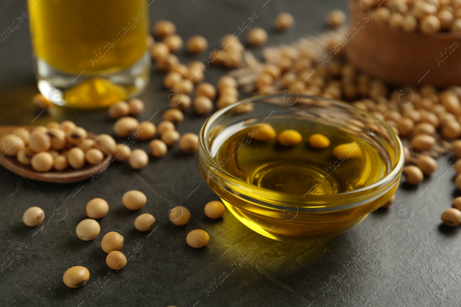 Photo of Composition with soybean oil on grey table, closeup