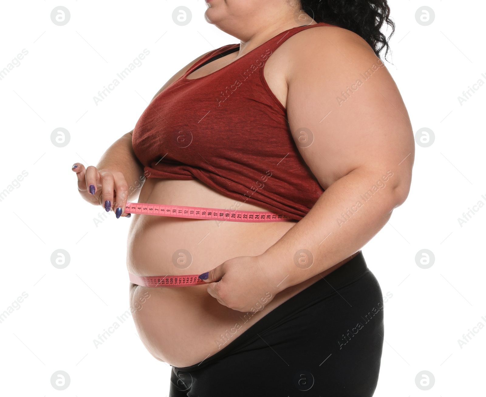 Photo of Overweight woman measuring waist with tape on white background, closeup