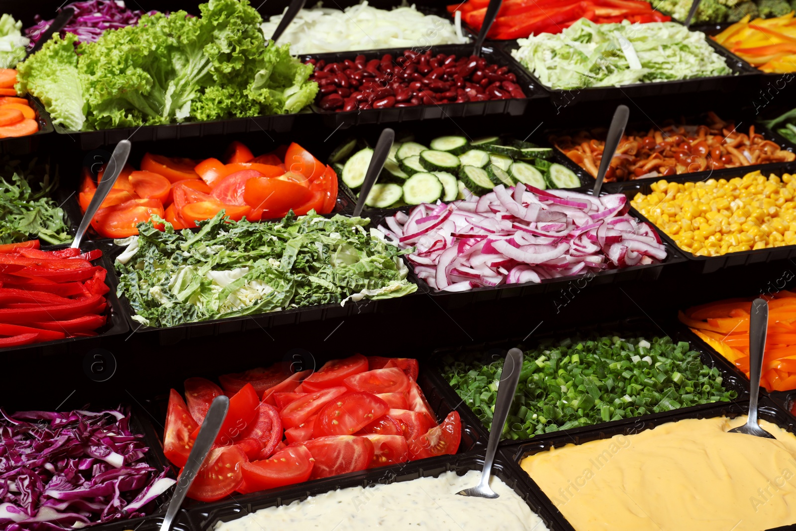 Photo of Salad bar with different fresh ingredients as background