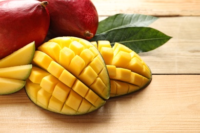 Photo of Composition with fresh mango on light wooden background, closeup