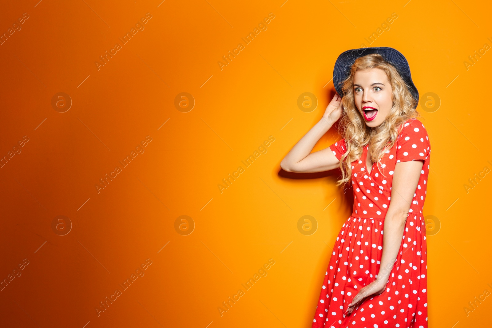 Photo of Emotional stylish young woman on color background
