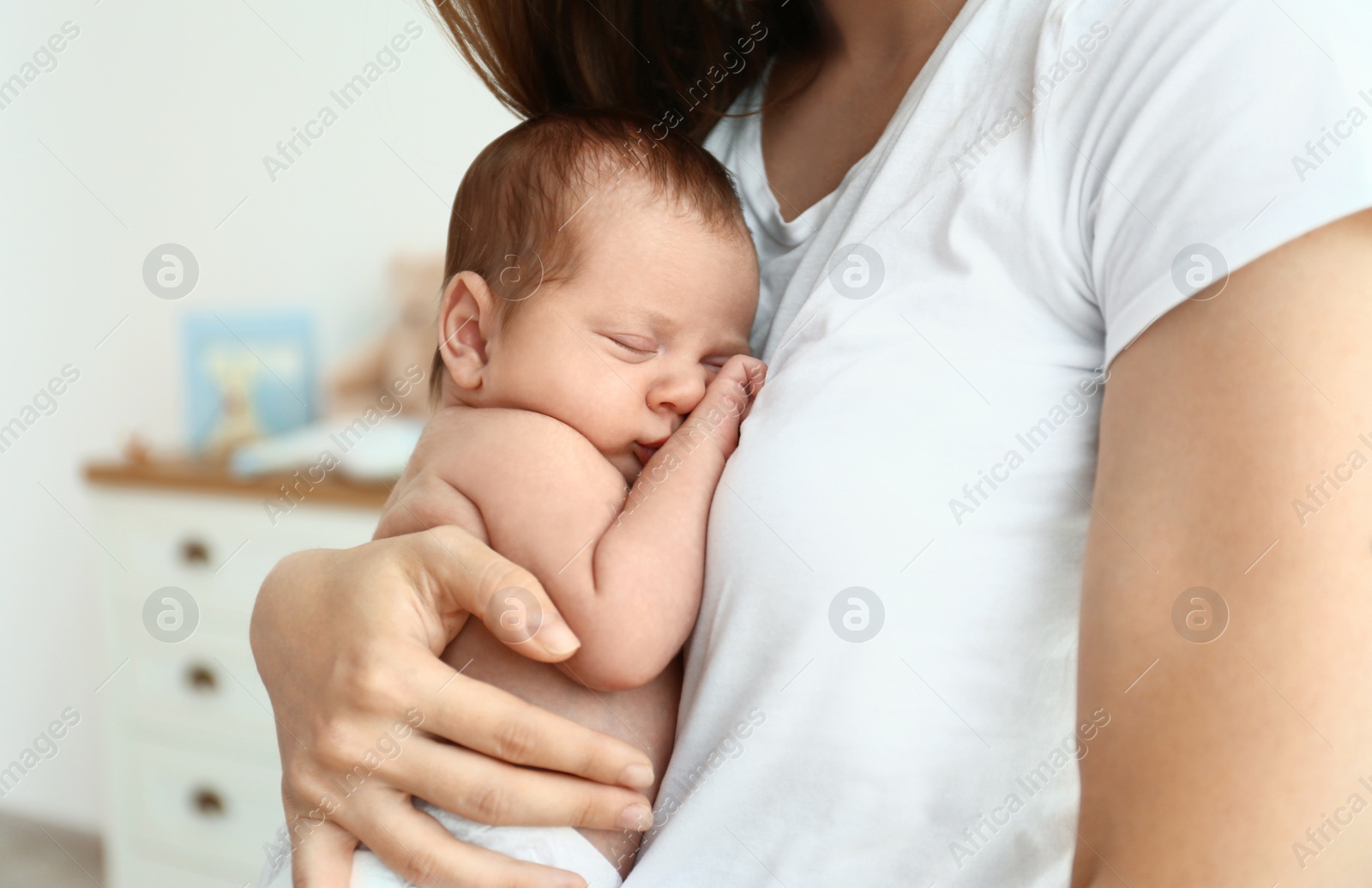 Photo of Young mother with her cute baby at home