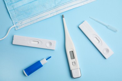 Photo of Disposable express test kit for hepatitis on light blue background, flat lay