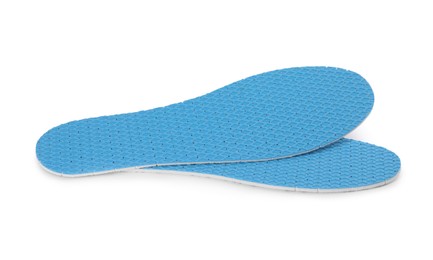 Photo of Pair of light blue insoles on white background