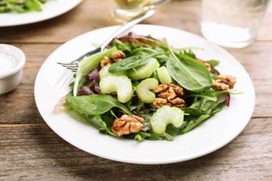 Photo of Delicious fresh celery salad on wooden table, closeup