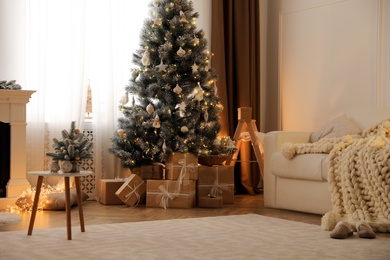 Photo of Beautiful living room interior with decorated Christmas tree and gifts
