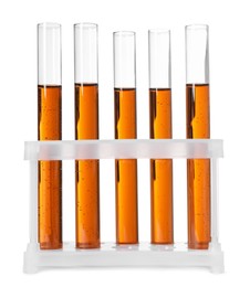 Photo of Test tubes with brown liquid in stand on white background