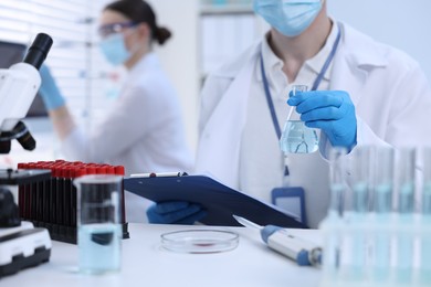 Scientists working with samples in laboratory, closeup. Medical research