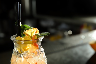 Photo of Fresh alcoholic cocktail Tequila Sunrise in bar, closeup. Space for text