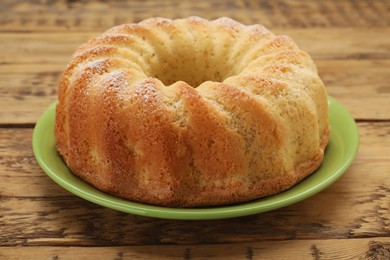 Photo of Delicious freshly baked sponge cake on wooden table, closeup