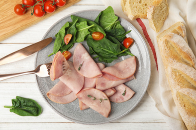 Photo of Tasty ham served on white wooden table, flat lay