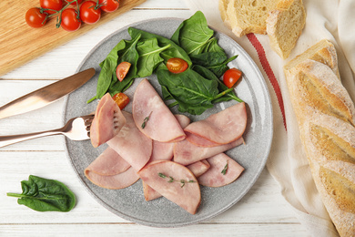 Tasty ham served on white wooden table, flat lay