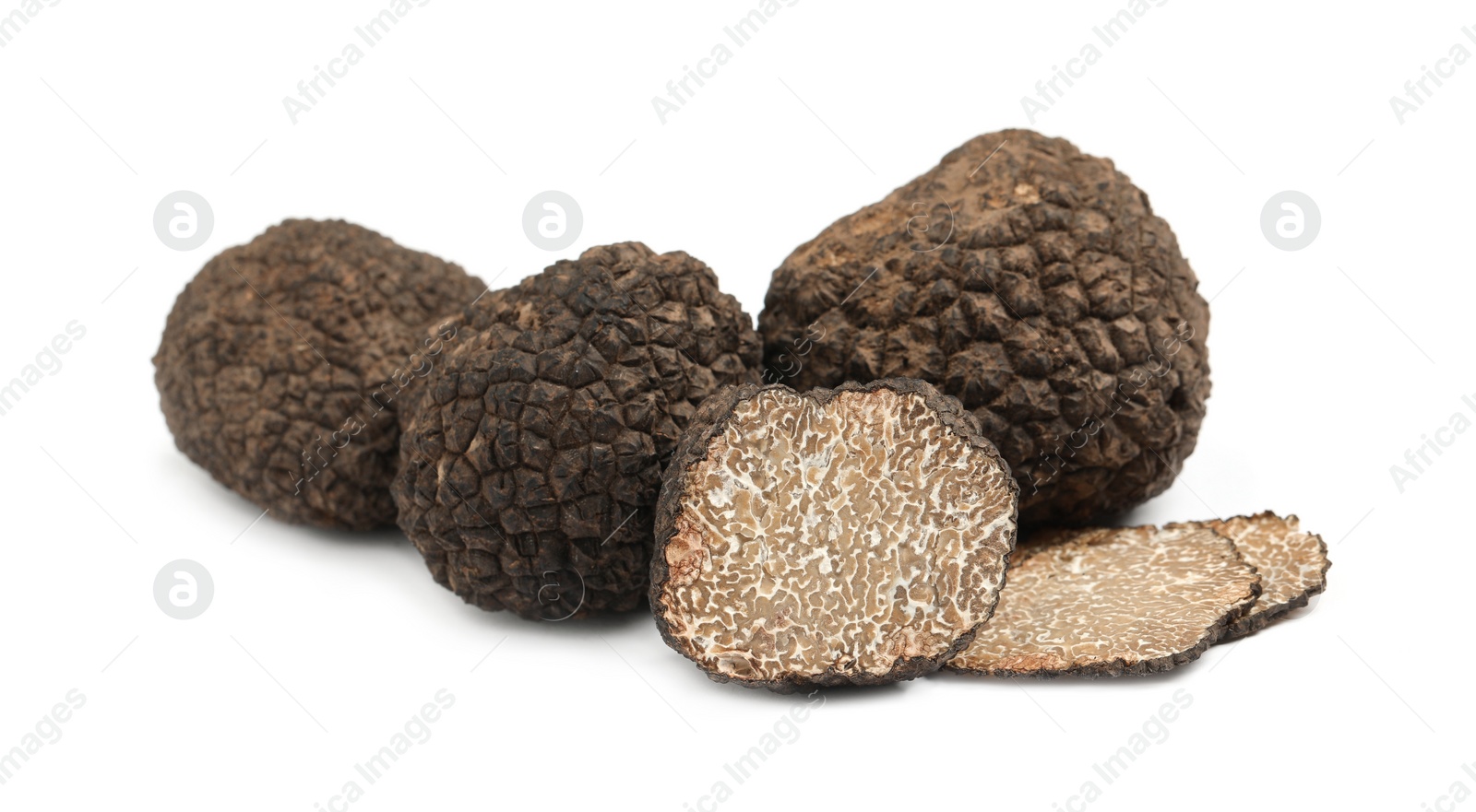 Photo of Cut and whole black truffles isolated on white