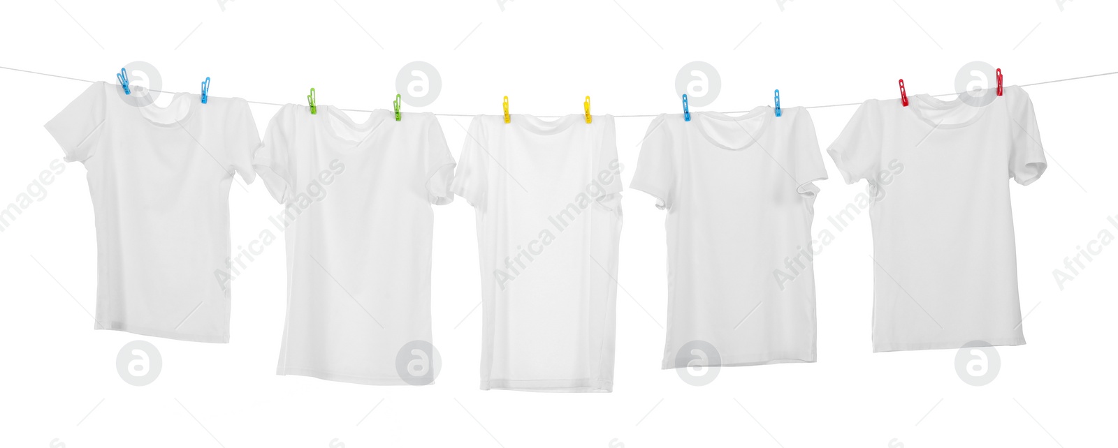 Photo of Many t-shirts drying on washing line isolated on white