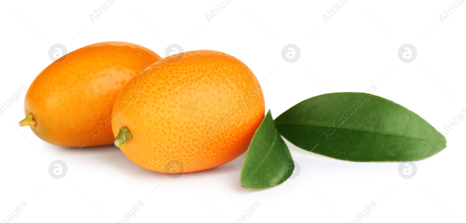 Photo of Fresh ripe kumquats with leaves on white background. Exotic fruit