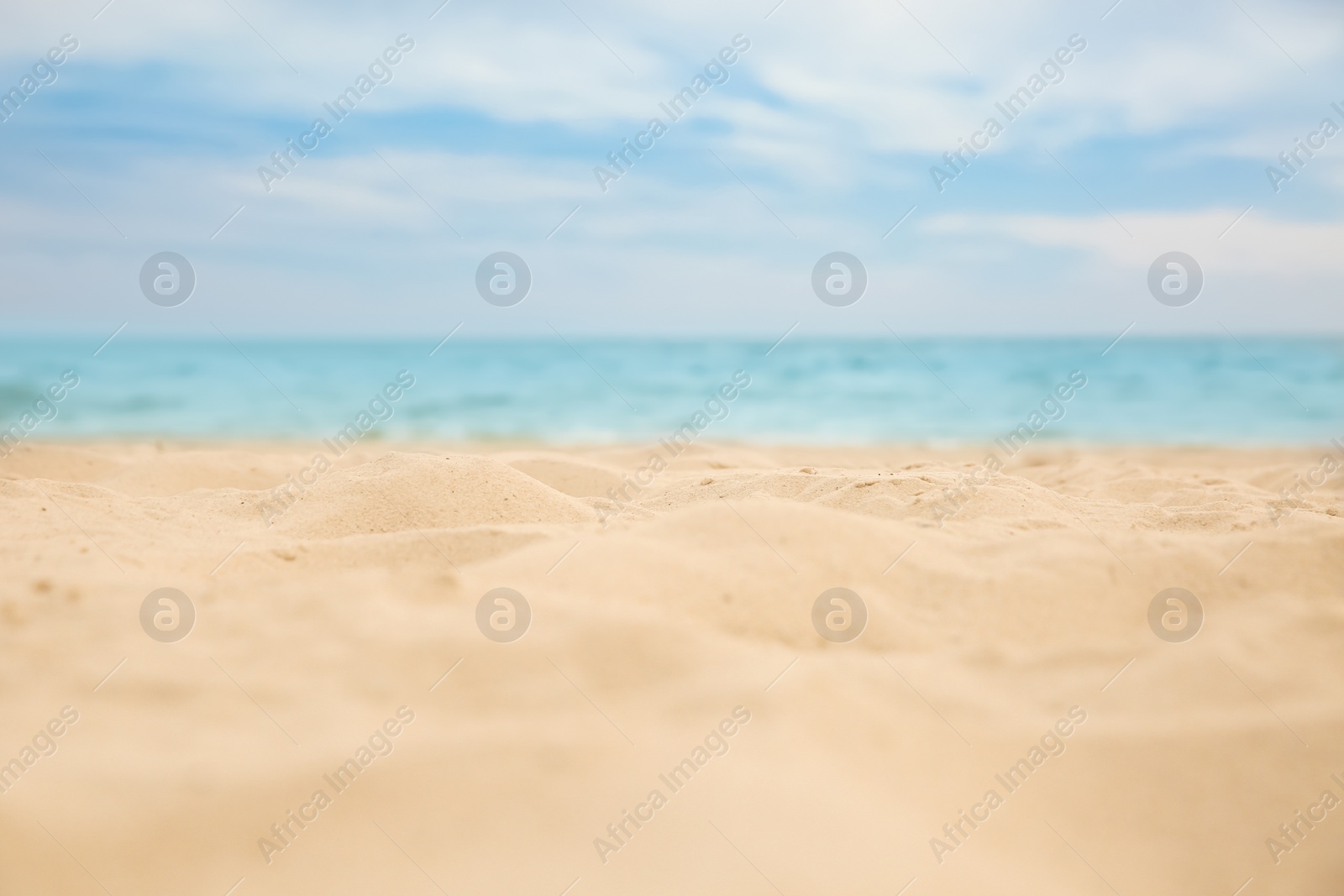 Photo of Beautiful sandy beach and sea on sunny day, closeup. Summer vacation