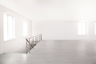 Photo of Empty room with windows and laminated floor