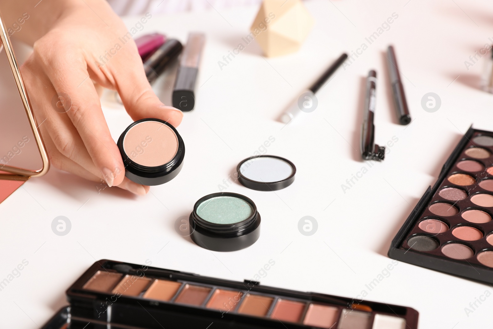 Photo of Beauty blogger with eyeshadow at table, closeup