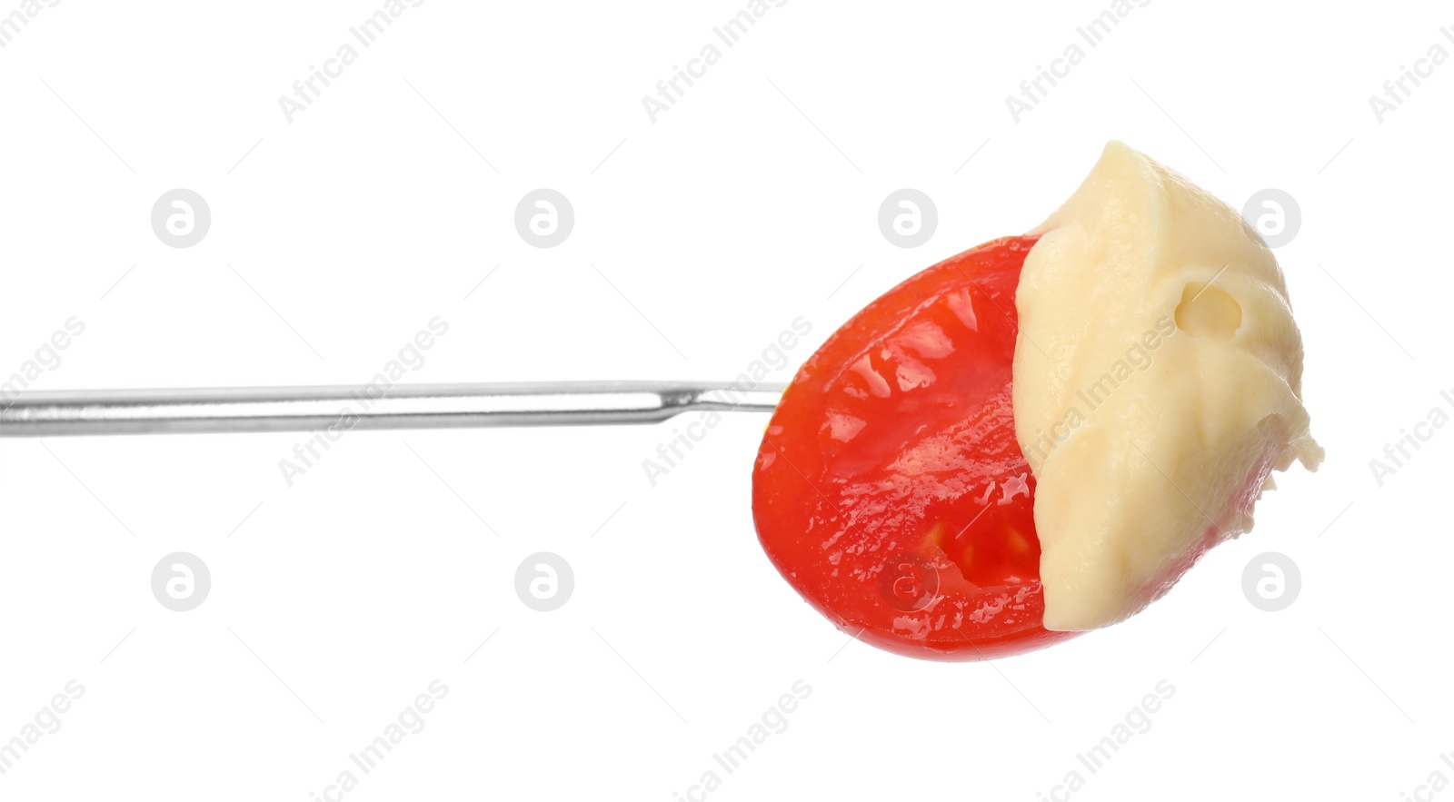 Photo of Tasty fondue. Fork with tomato and melted cheese isolated on white