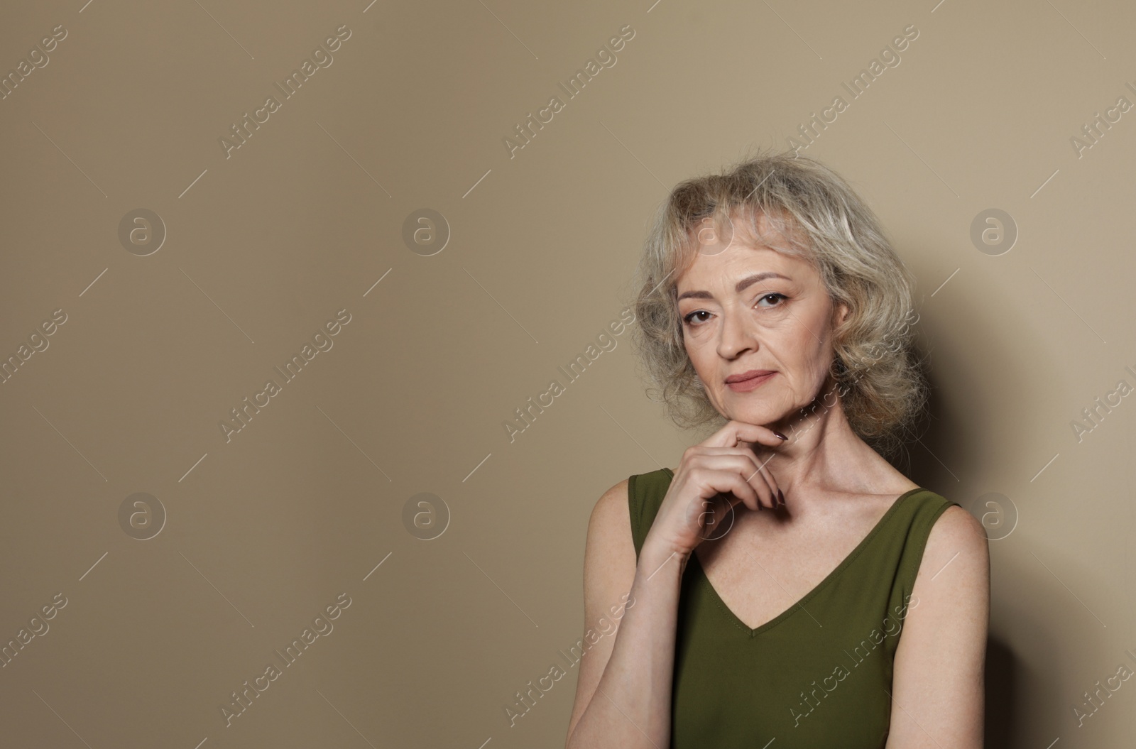 Photo of Portrait of mature woman on color background. Space for text