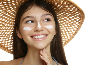 Photo of Teenage girl with sun protection cream on her face against white background