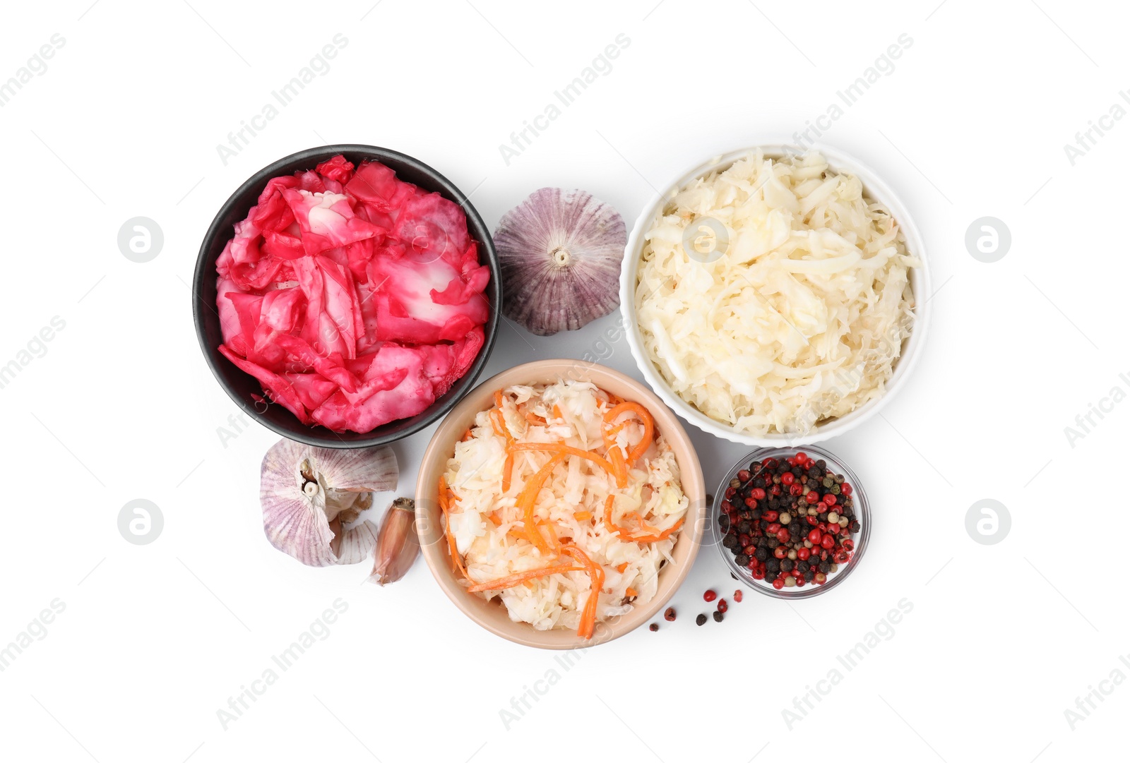 Photo of Delicious sauerkraut prepared according to different recipes and spices on white background, top view