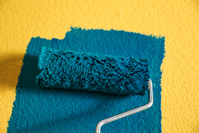 Photo of Painting yellow wall with blue dye, closeup view