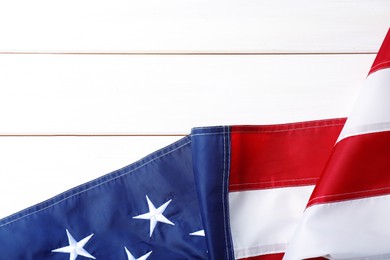 Photo of National flag of America and space for text on white wooden table, top view