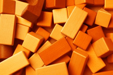 Image of Orange wooden construction set as background, top view