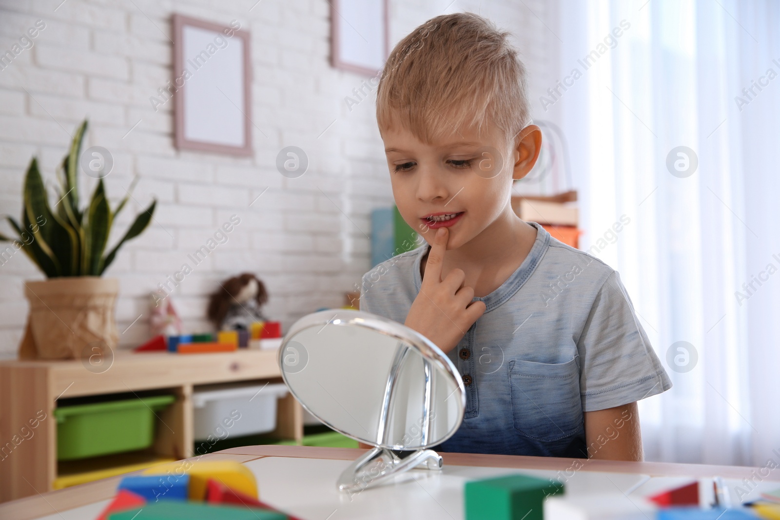 Photo of Cute little boy at speech therapist office