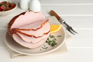 Photo of Cut delicious ham on white wooden table
