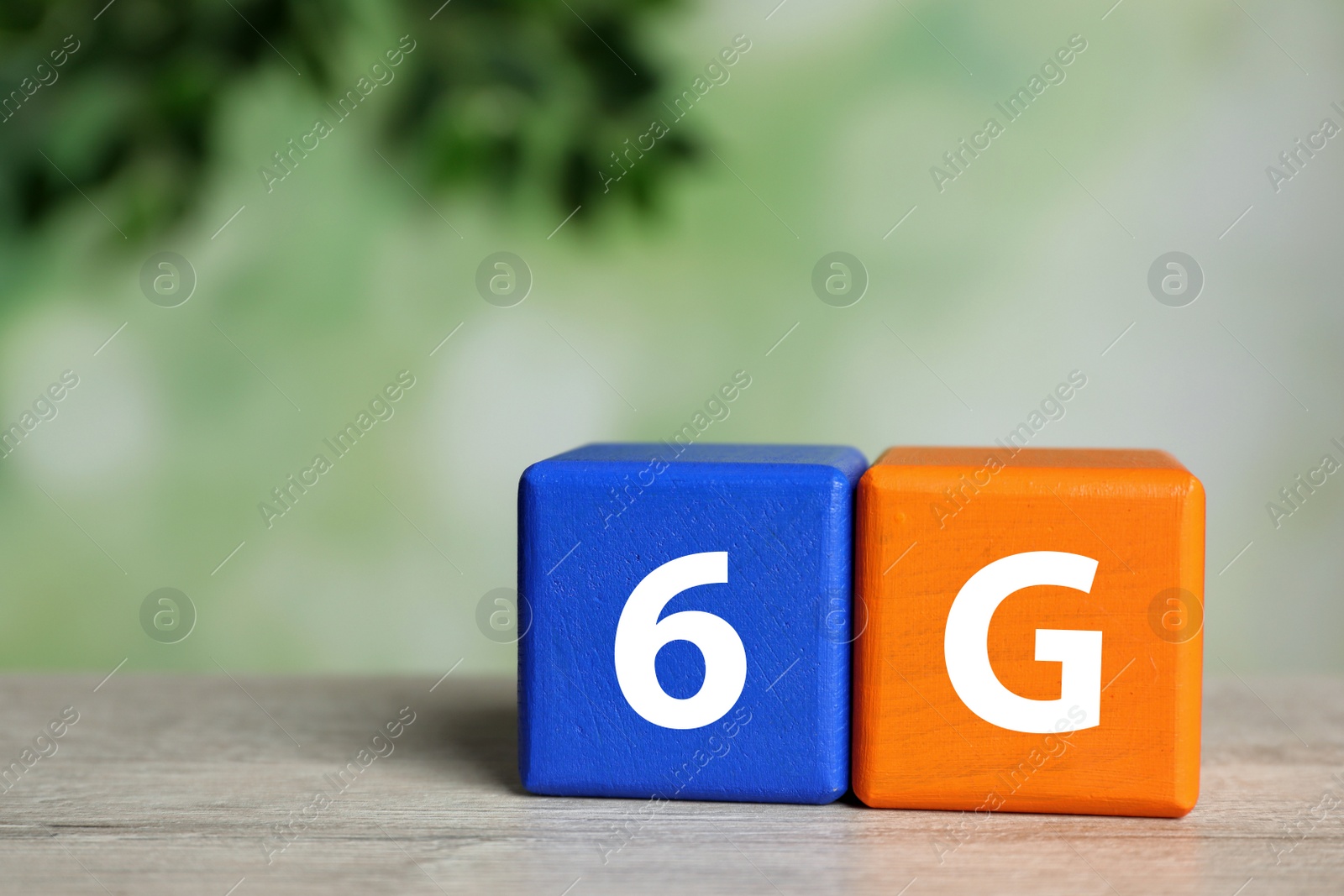 Photo of 6G technology, Internet concept. Color cubes on wooden table