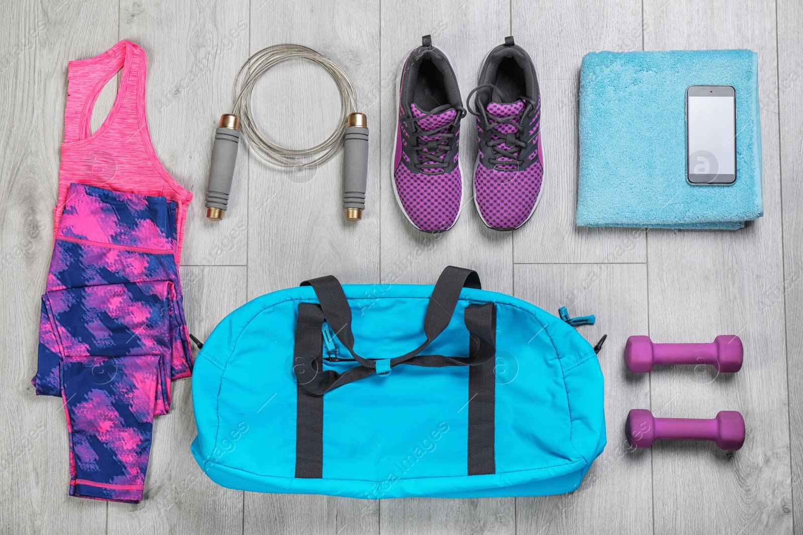 Photo of Flat lay composition with sports bag on wooden floor