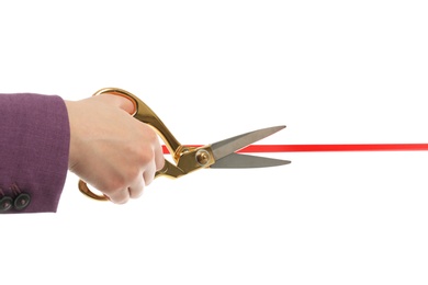 Photo of Woman in office suit cutting red ribbon isolated on white, closeup