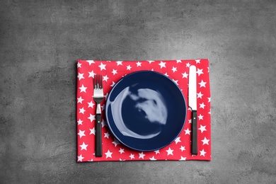 Photo of Patriotic table setting with traditional USA colors on grey background, top view