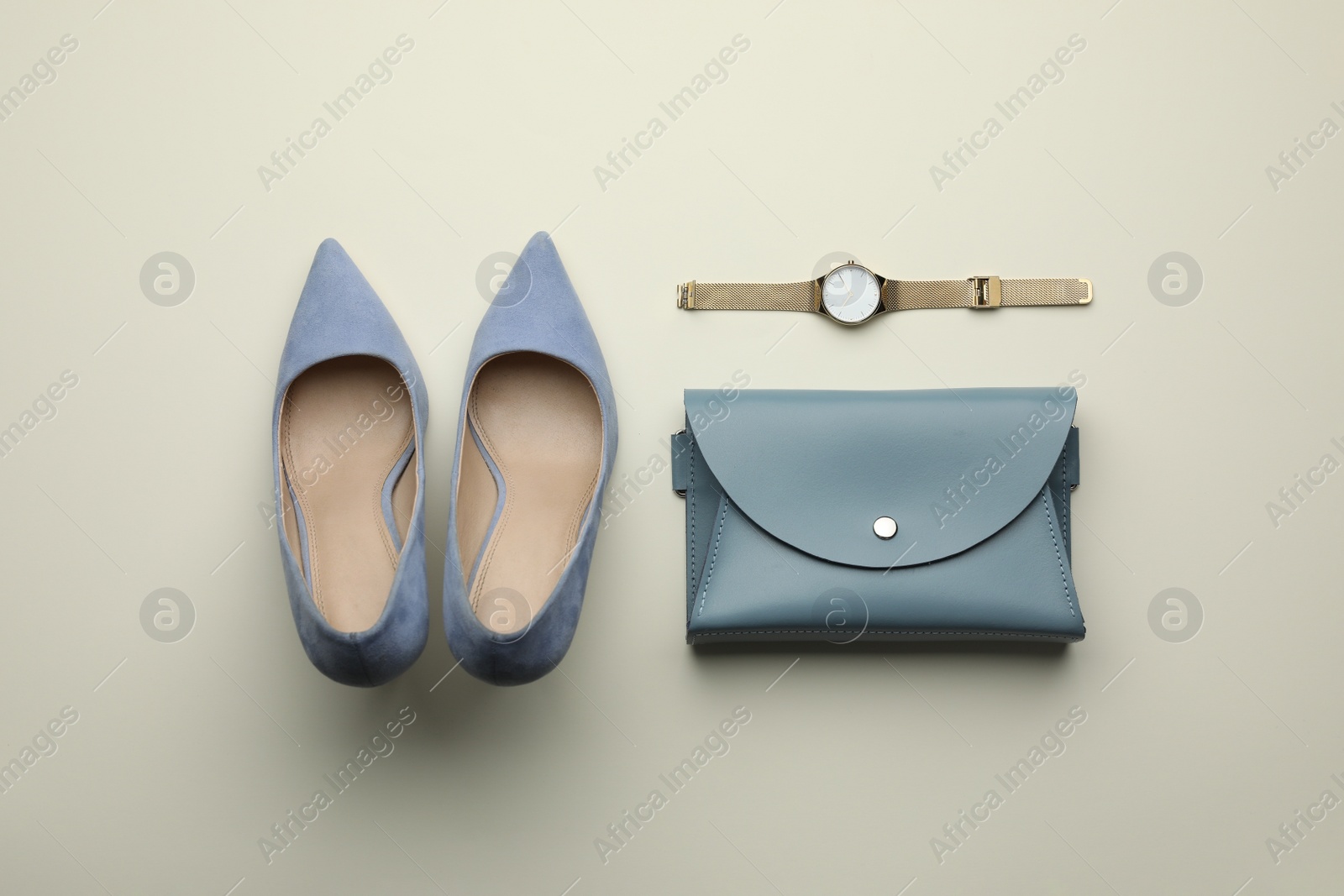 Photo of Stylish woman's bag, shoes and watch on light background, flat lay