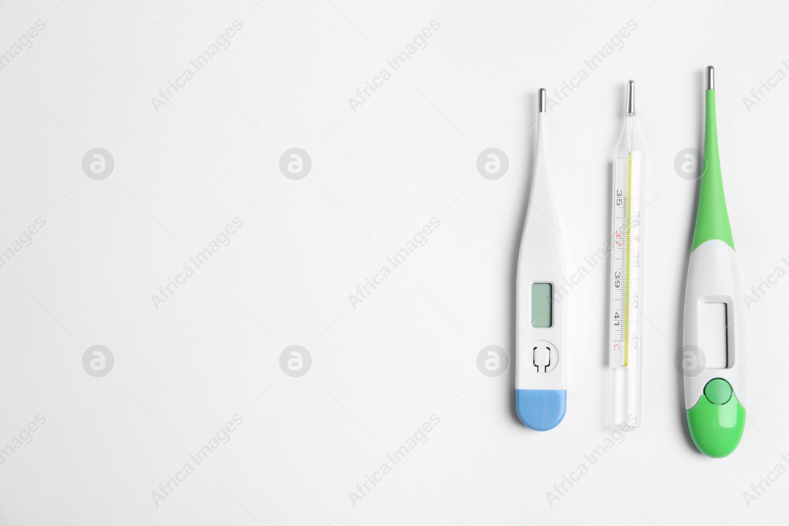 Photo of Different thermometers on white background, flat lay. Space for text