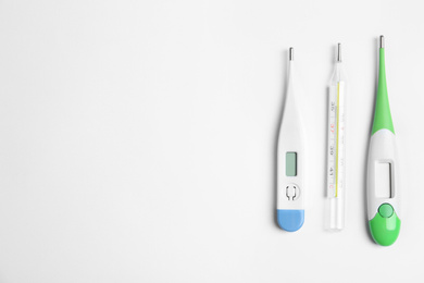 Different thermometers on white background, flat lay. Space for text