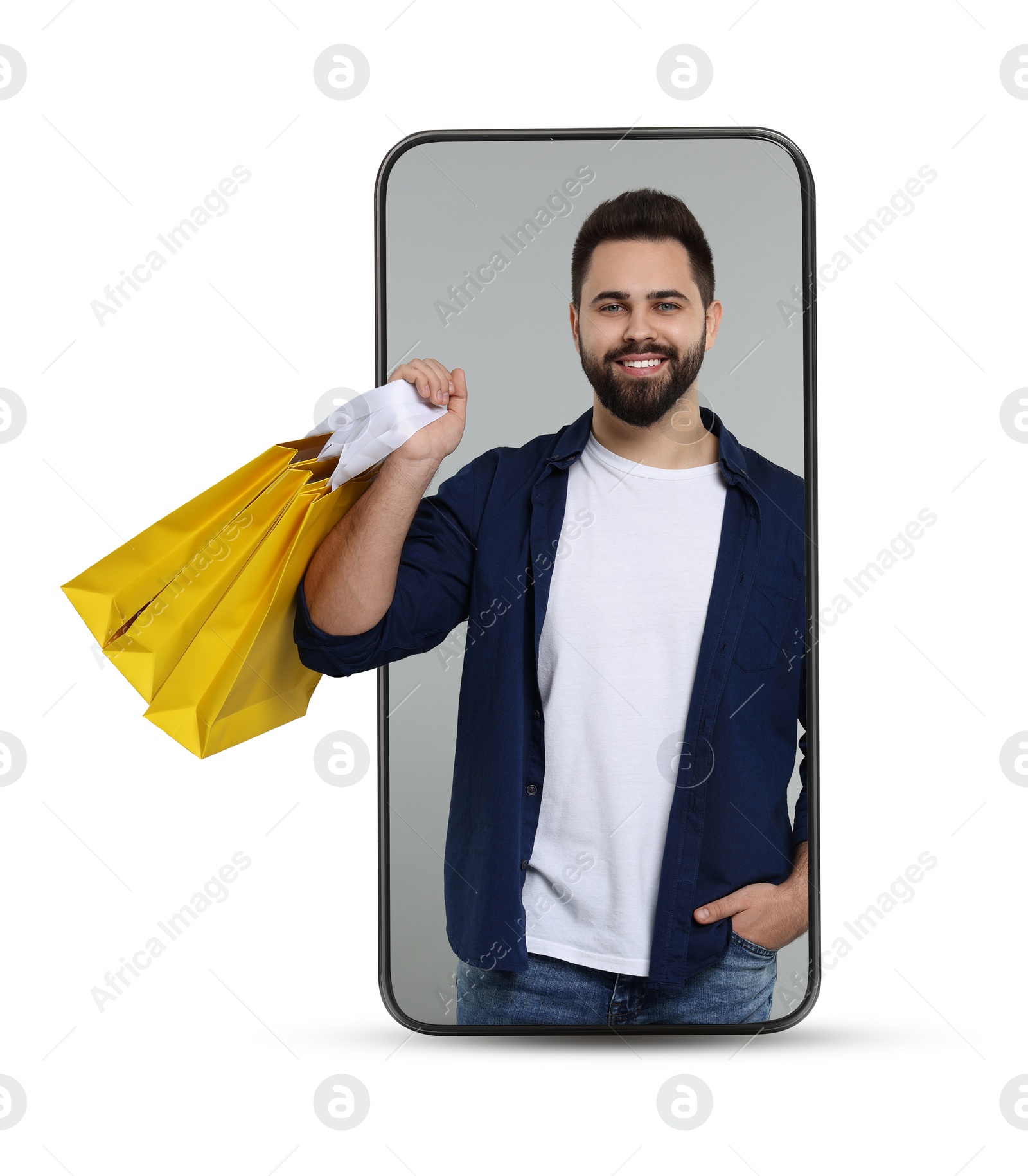 Image of Online shopping. Happy man with paper bags looking out from smartphone on white background