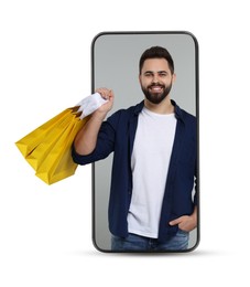 Online shopping. Happy man with paper bags looking out from smartphone on white background