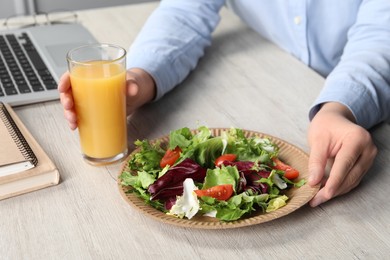 Office employee having business lunch at workplace, closeup