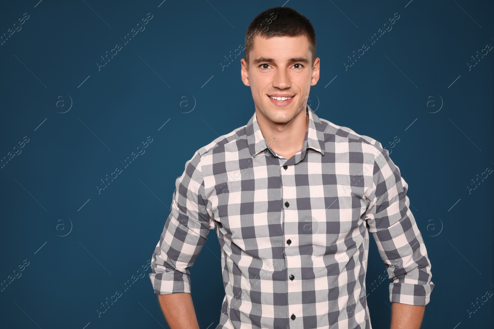 Photo of Portrait of handsome young man on blue background